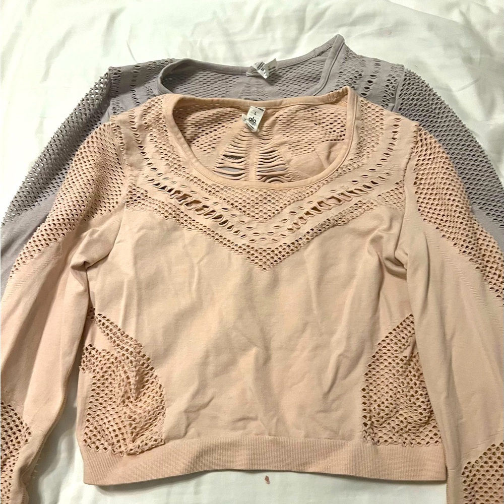 2 ALO Crop Cut Out Shirts. One in purple is medium and the pink is large.